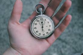 Hand holding stopwatch.